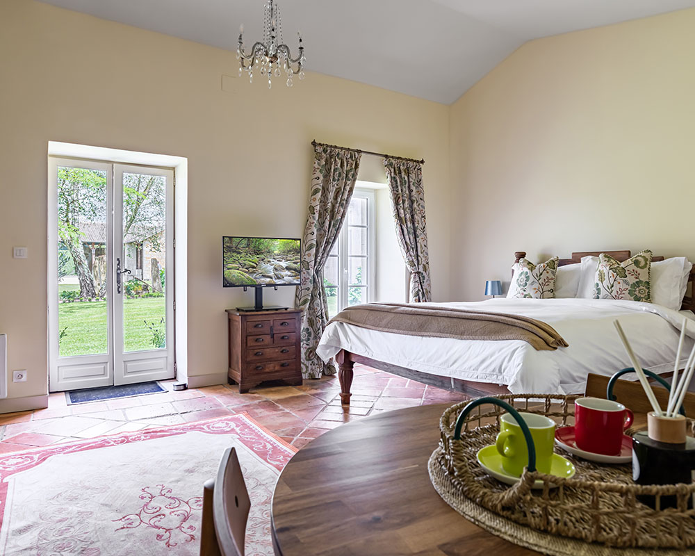 Open bedroom with large light windows and authentic rug on the floor