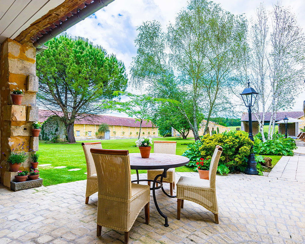 Outside kitchen overlooking a garden and trees