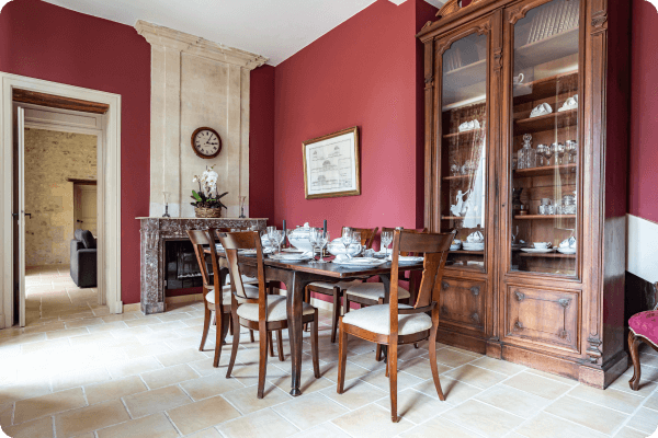 Classic french style dining room with red wall paper and oak furniture