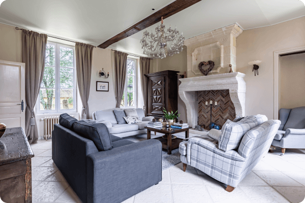 Reading room with large open fireplace and classic french decor