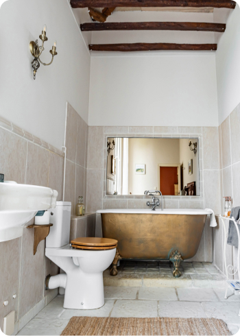 Roll top bath tub with beamed roof and white tiles