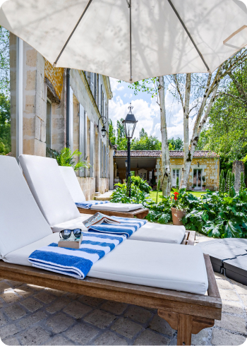 Sun lounges outside an indoor heated swimming pool