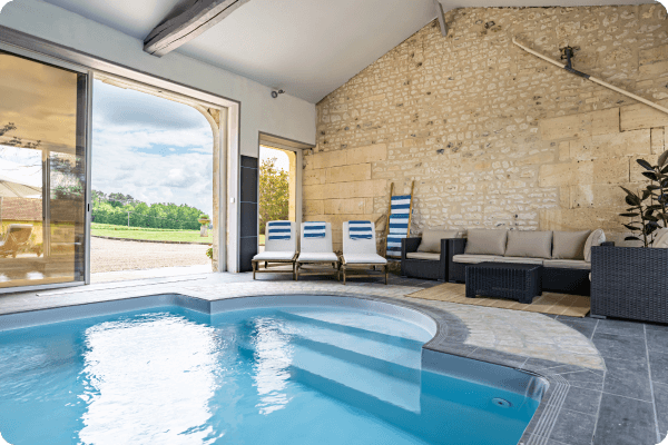 Large blue swimming pool inside limestone building