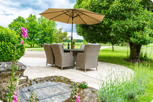 Outdoor seating in front a large open lawn