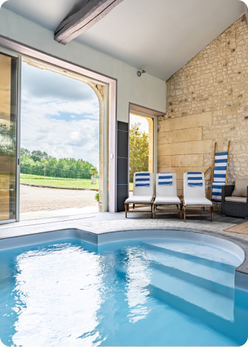 Large blue swimming pool inside limestone building